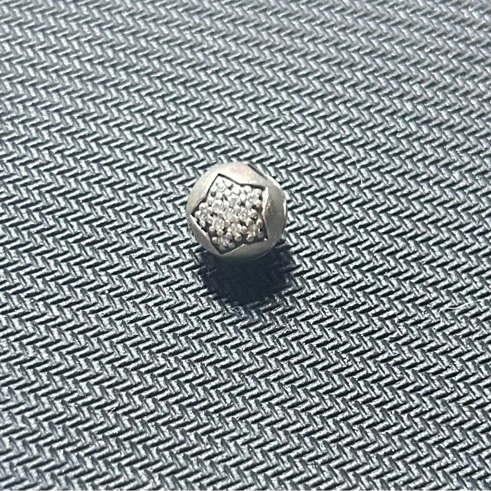 Authentic pandora twinkle star charm.